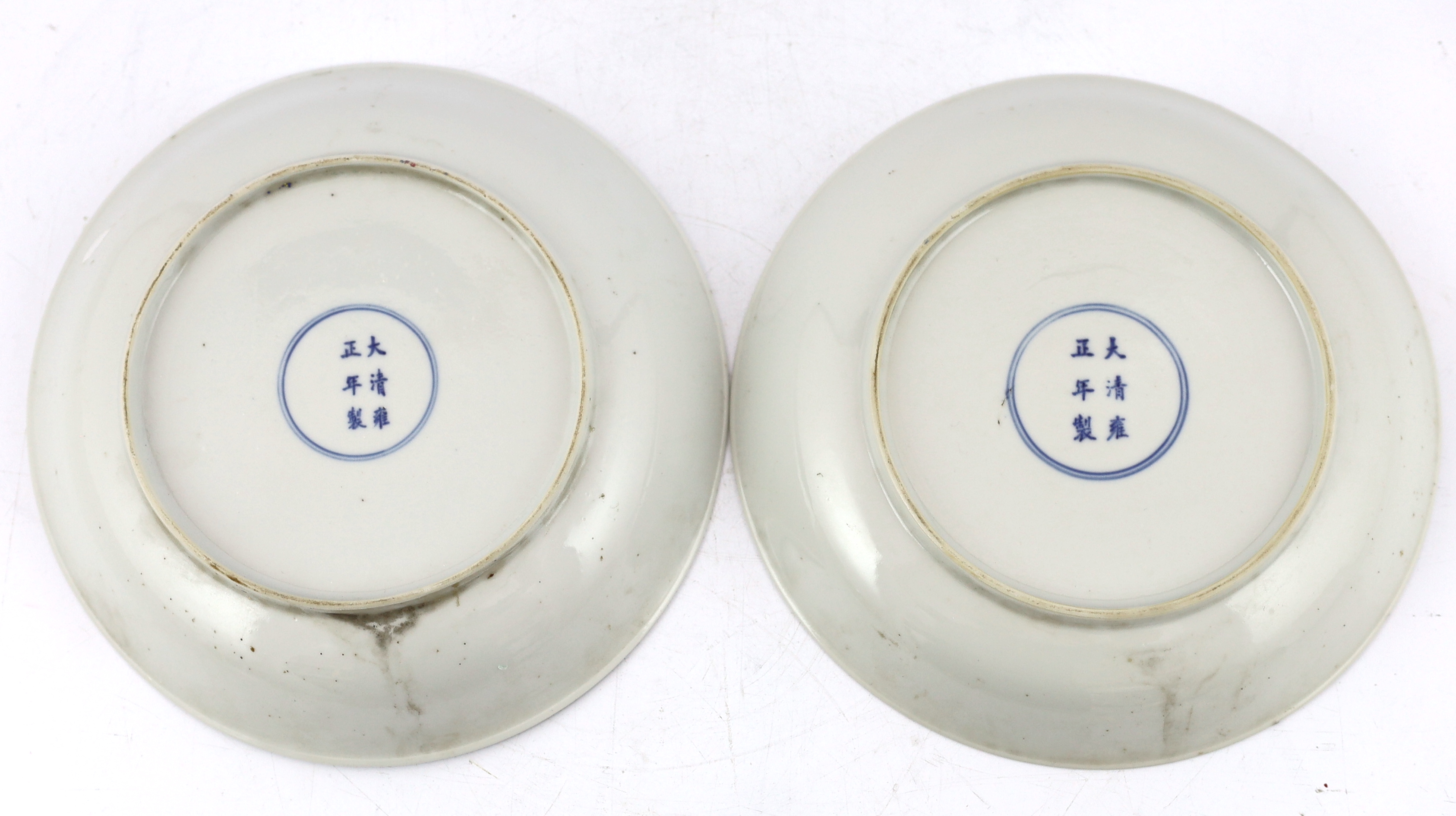 A pair of Chinese famille rose saucer dishes, Yongzheng mark but first half 19th century, one dish has a short hairline crack